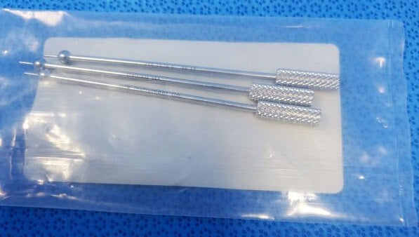 Cervical Disk Markers Set of 3 - A set of three cervical disk markers made of metal, packaged in a clear plastic bag on a blue background.