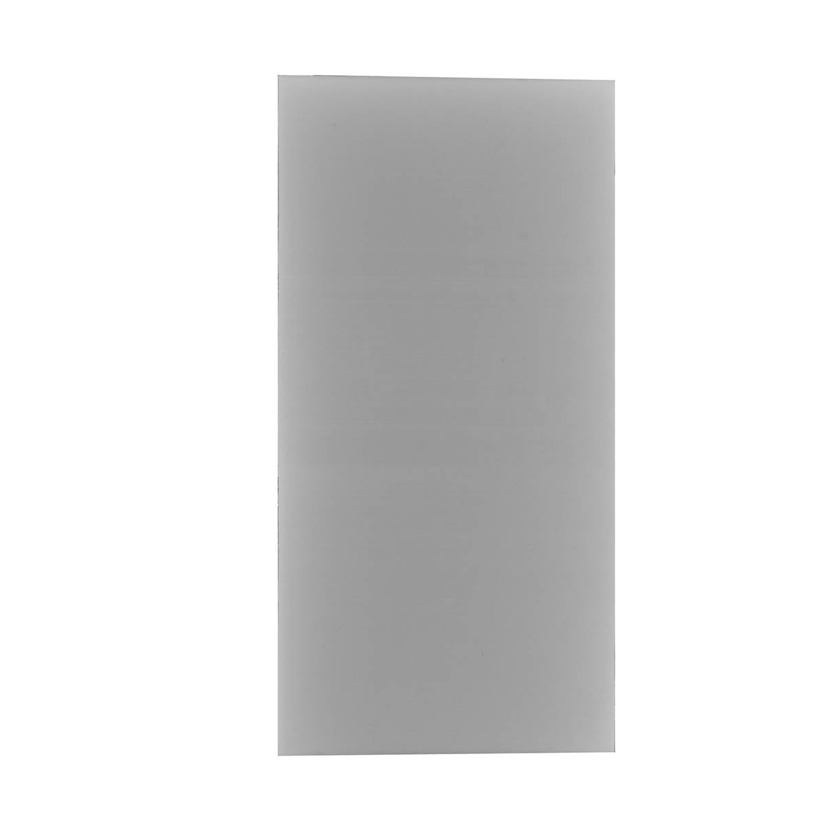 A gray metal surgical cutting block with a smooth surface, used for shaping and cutting bone or tissue in otologic procedures.